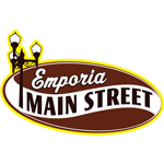 Emporia Main Street logo. The words are contained within a dark, reddish brown ellipse with a wavy, white line running across it. "Main Street" follows the path of the white line. An illustrated lamp post is on the left and peeks out from the ellipse. The entire logo has a yellow outline.